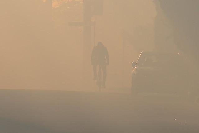 Man on bycycle with lots of smoke