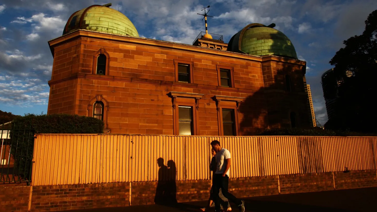 Man walking in front of Sydney Observatory
